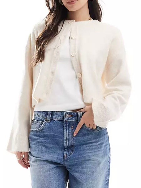 Image may contain Blouse Clothing Pants Long Sleeve Sleeve Knitwear Sweater and Jeans